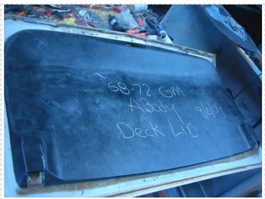 Blue metal tray with writing on the sides, containing items.