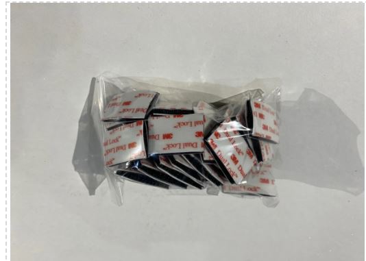 Packaged black hair clips on a white background