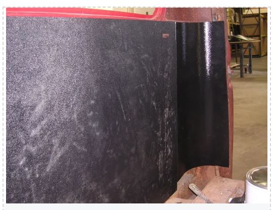 Black textured ABS rear cab cover panel installed against bare metal cab edge, shown during installation