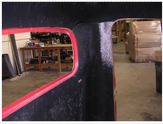 Workshop with a focus on a curved object with red trim