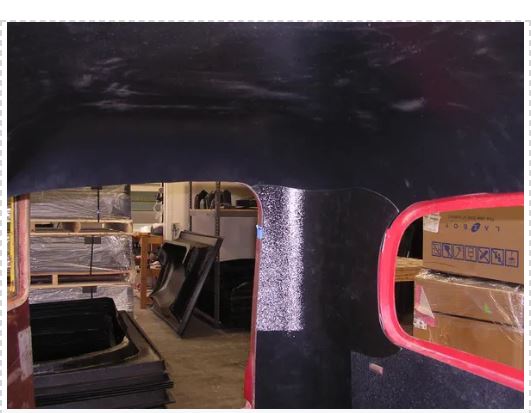 View of a storage room through a hole in a black tarp.