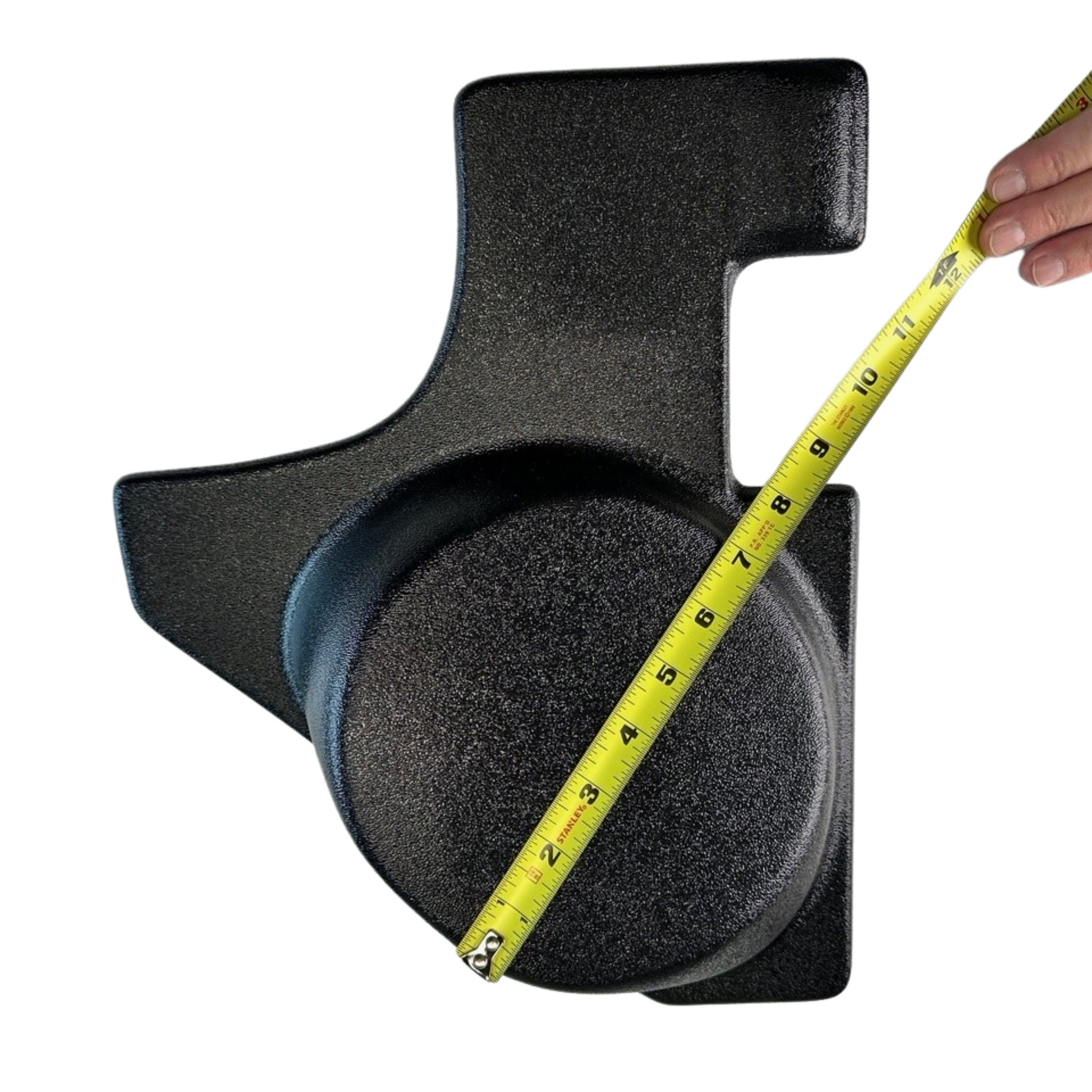 Black foam block with a yellow measuring tape on a white background