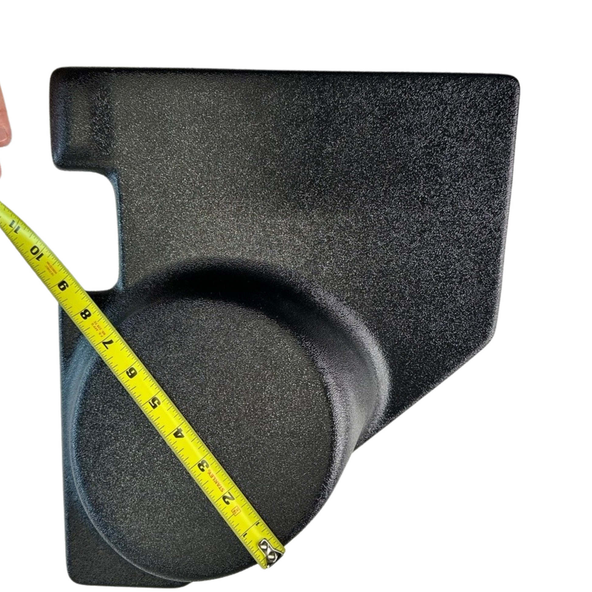 Black foam block with a measuring tape indicating dimensions on a white background