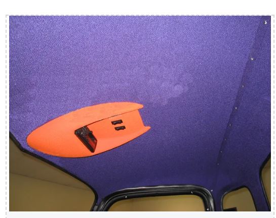 Orange surfboard attached to a purple car.