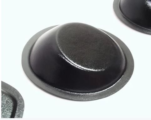 A black, round, universal modular speaker pod with a smooth surface.
