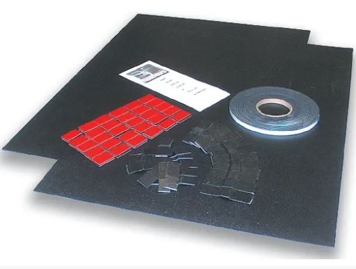 Flat stock door panels with installation kit, including black material and red Dual Lock tabs on a white background.