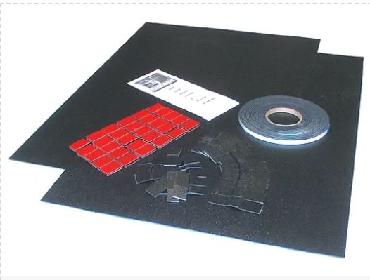An ABS sheet with a .090 inch thickness, alongside a roll of tape and a piece of paper with red markings, on a white background.