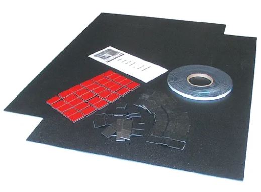 A pair of black flat stock kick panels with installation kit including Dual Lock tabs and a roll of tape.