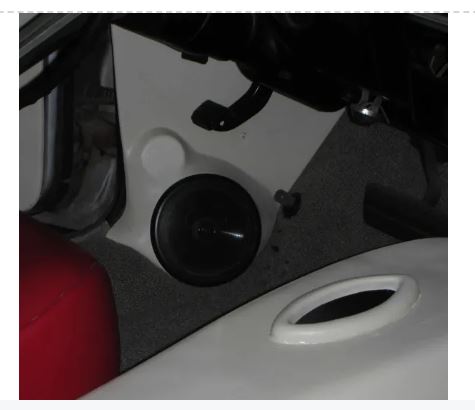 Close-up of a black kick panel with a speaker mount hole for a 1967-1969 Chevrolet Camaro.